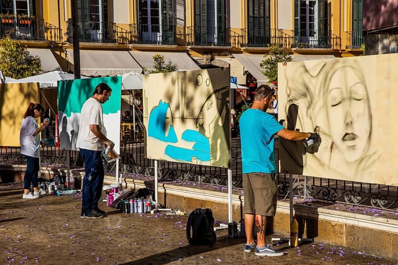 Plaza de la Merced with street painters and the birthplace of Pablo Picasso on the north-western side
