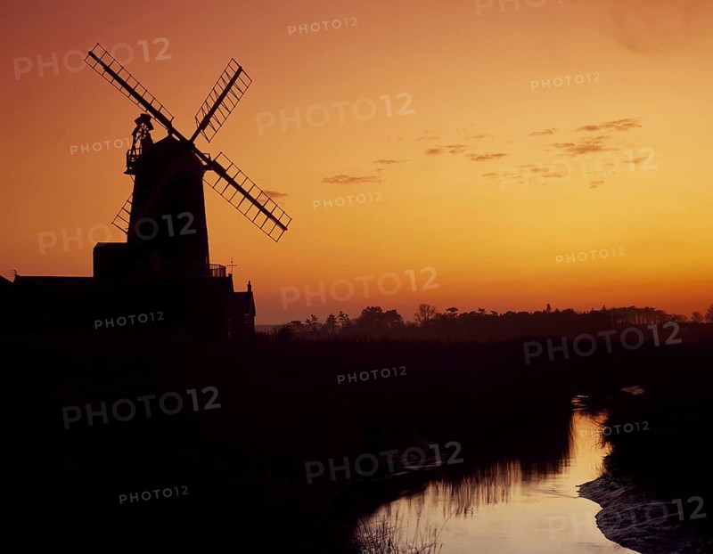 Windmill silhouetted at sunset