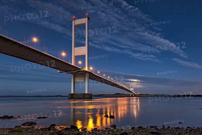 View of road bridge and rising full moon