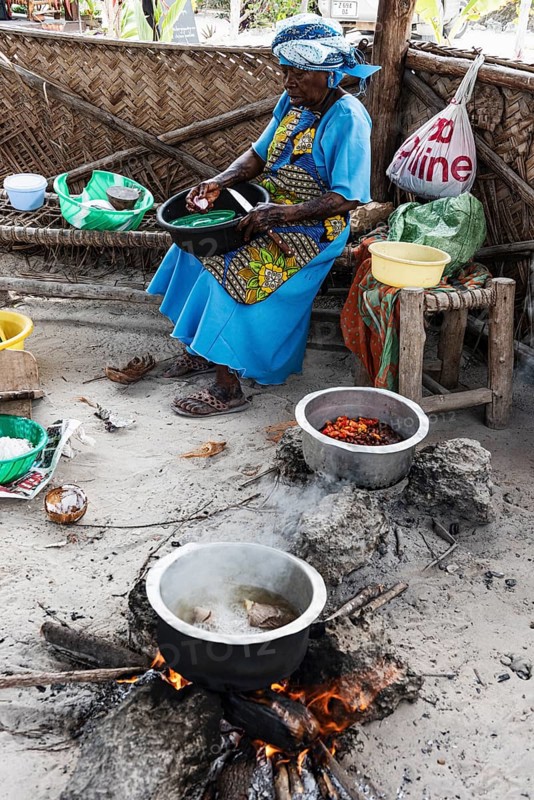 Woman cooking over an open fire