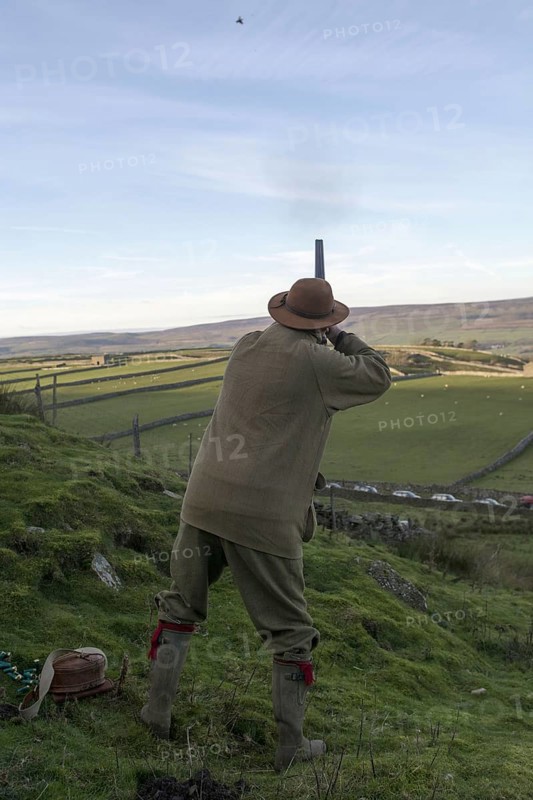Man with a 12-gauge shotgun