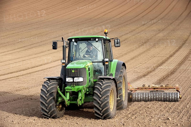 John Deere tractor pulling the soil press