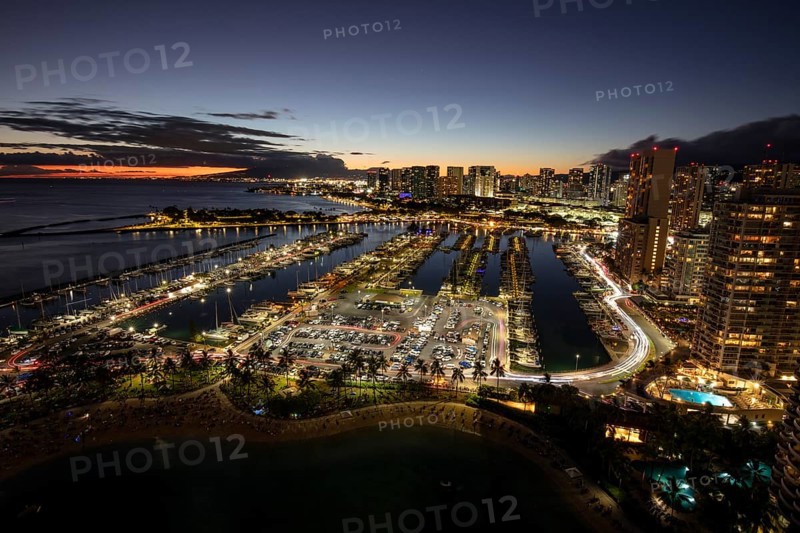Dusk at the Ala Wai boat harbour with a view over Waikiki to Honolulu