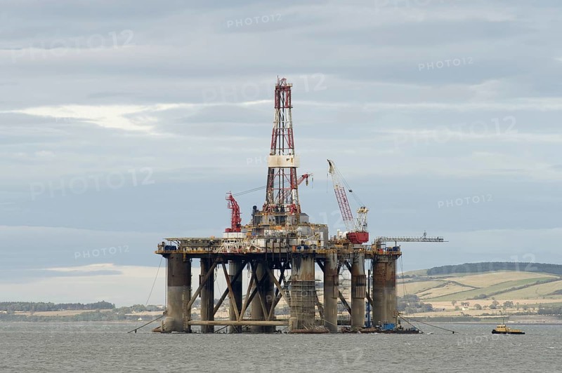 Oil rig moored in sea near coast