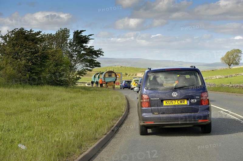 Traffic jam behind horse-drawn gypsy carts on the road to Appleby Fair