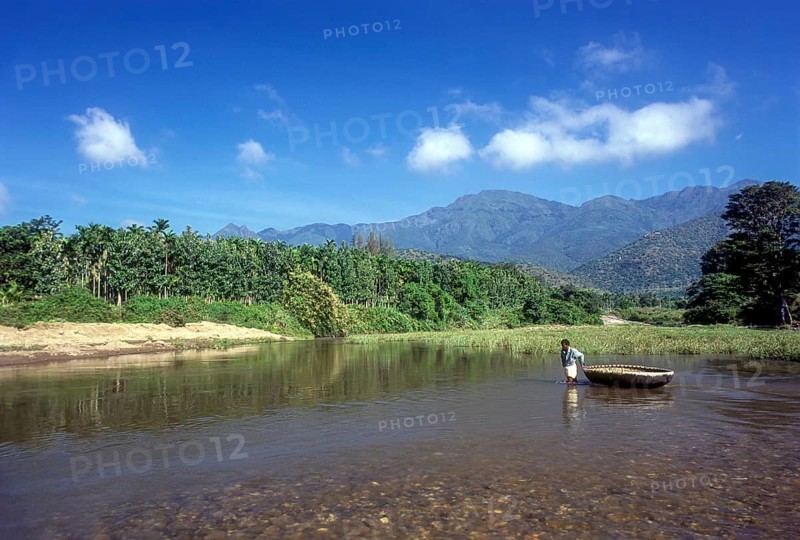 A man pulling the coracle on the Bhavani river in Attappadi