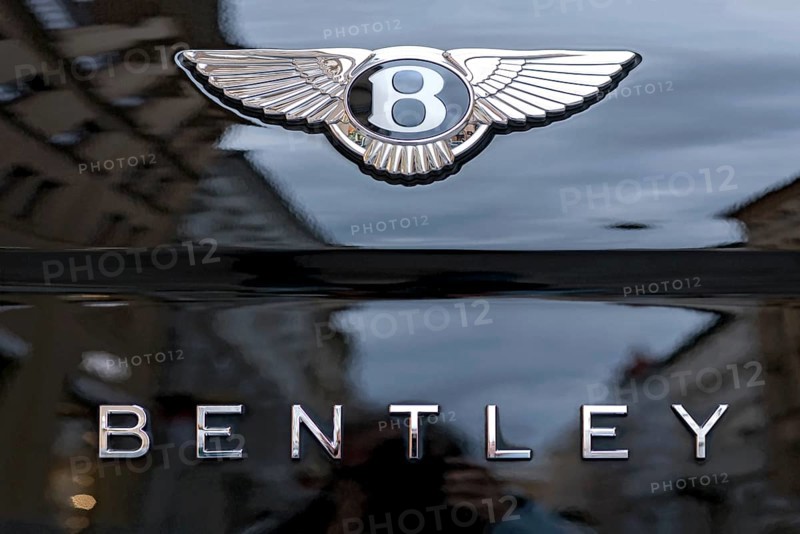 Logo and lettering of the Bentley car brand on a Bentley Flying Spur luxury saloon