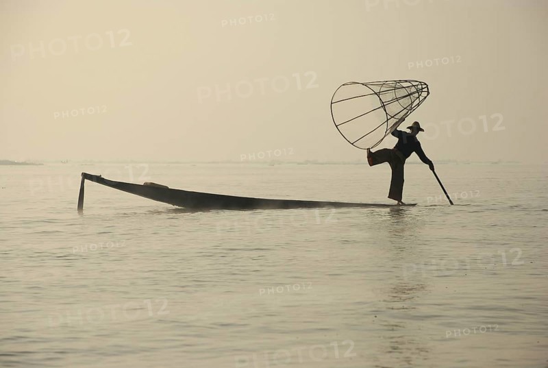 Traditional fisherman with fish trap in boat