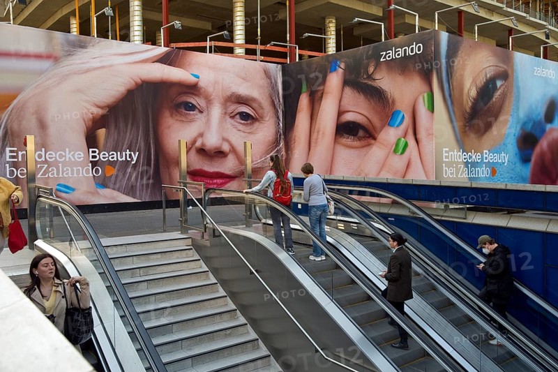 Large advertising posters on the stairs to the underground to hide the construction site behind