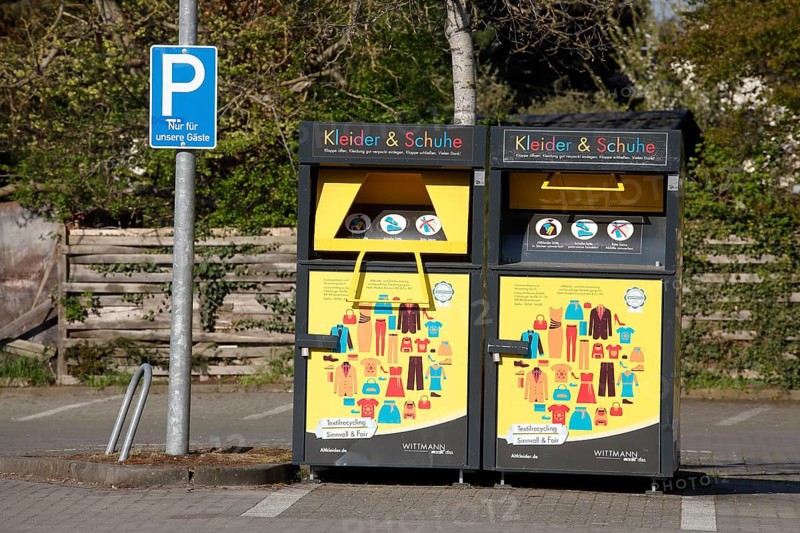 Used clothing container for clothes and shoes in a car park