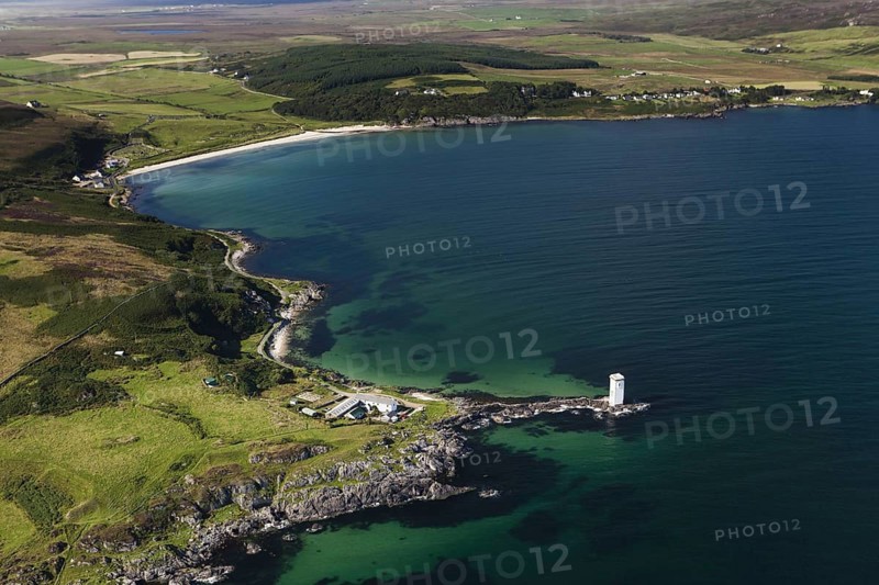 Aerial view of coastline and lighthouse