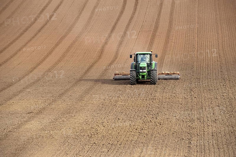 John Deere tractor pulling the soil press