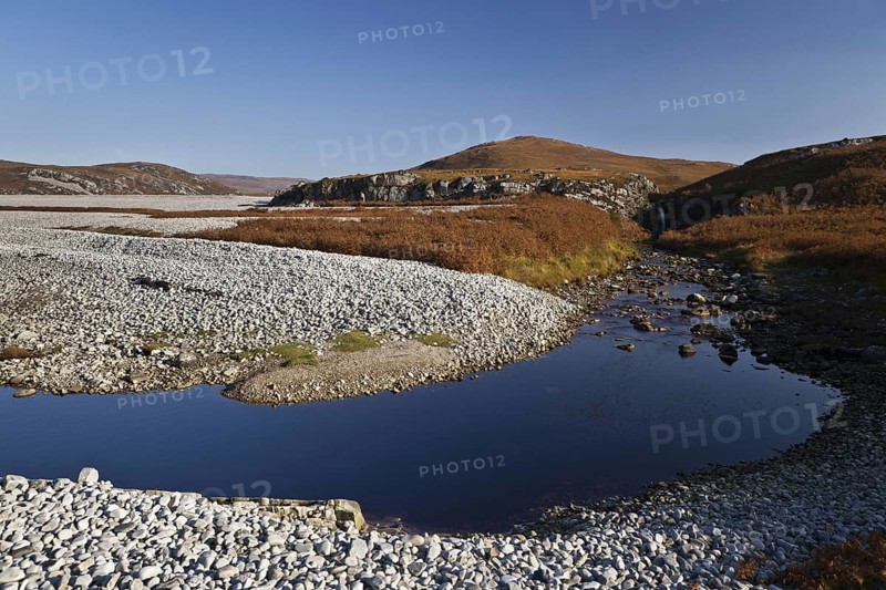 View of raised beach and waterfall near freshwater lochan