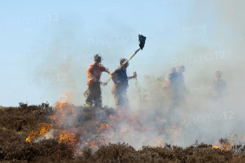 Firefighters tackling heather moor fire on a shooting range that had got out of control