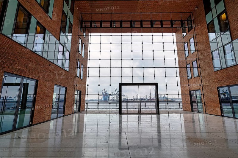 View through modern glass facade with large door onto the harbour
