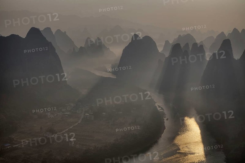 View of limestone karst formations along the river at sunrise
