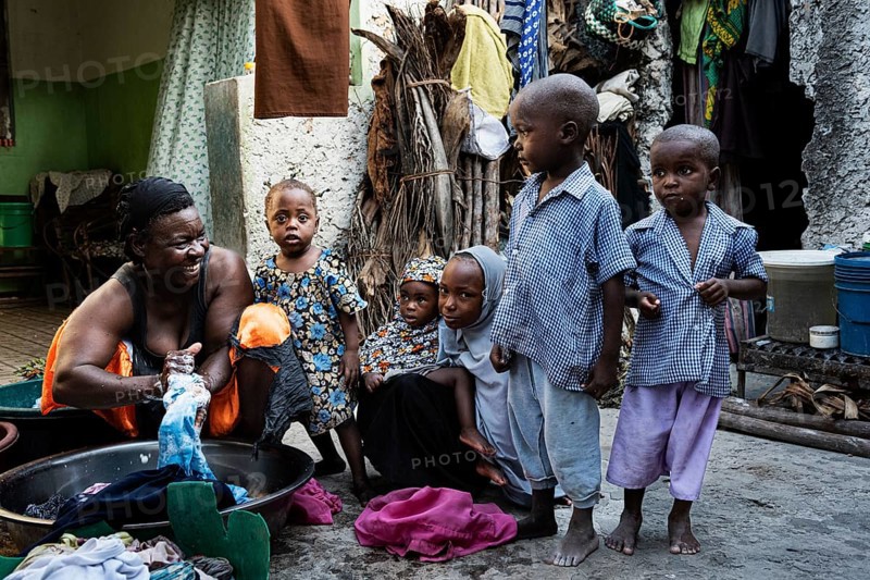 Woman with laundry in plastic bowl