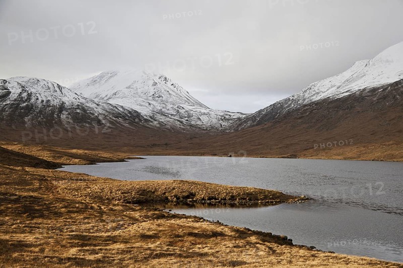 View across freshwater loch towards fishing hut
