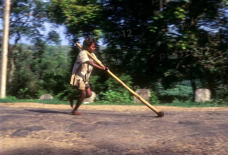 Tribal boy playing improvised pulley