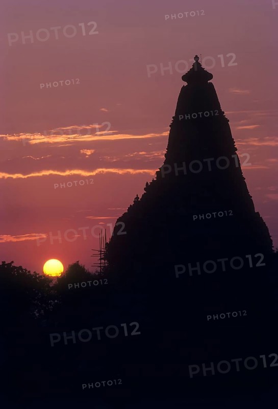 The Kandariya Mahadeva temple against glowing sun set in the Khajuraho