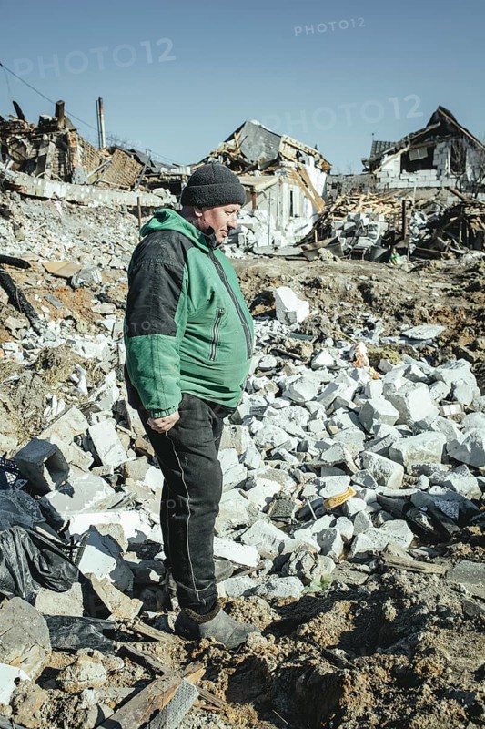 Serhiy Melnyk stands on the ruins of his house in the residential district of Bohunia