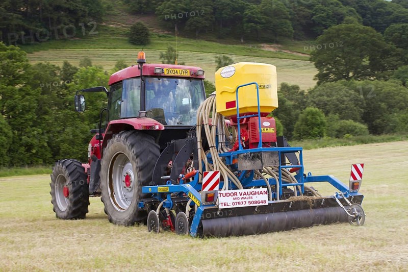 Contractor with McCormick MC120 tractor and ERTH Agriseeder precision slot seeder