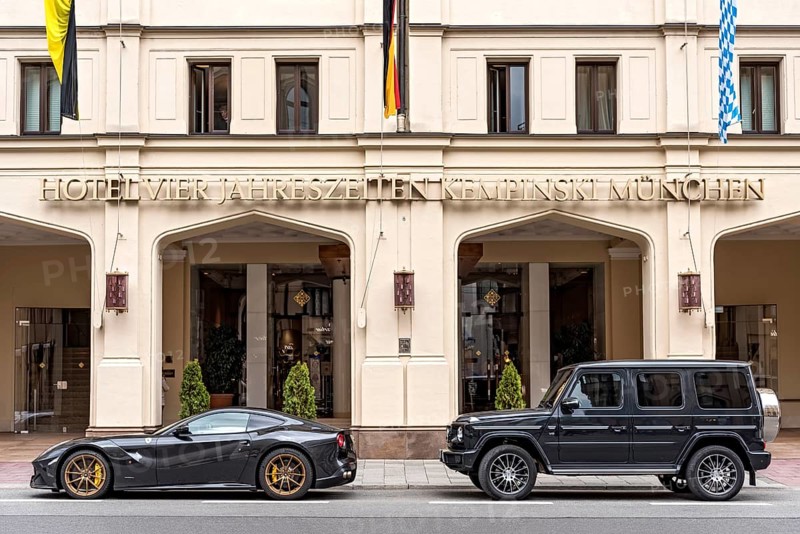 Parked sports car Ferrari F12 Berlinetta and SUV Mercedes-Benz AMG G 63