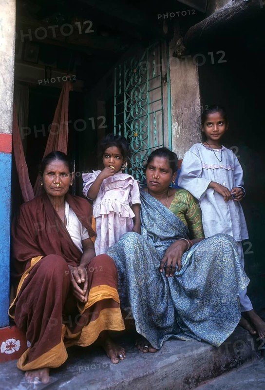 Fisher women sitting infront of the house