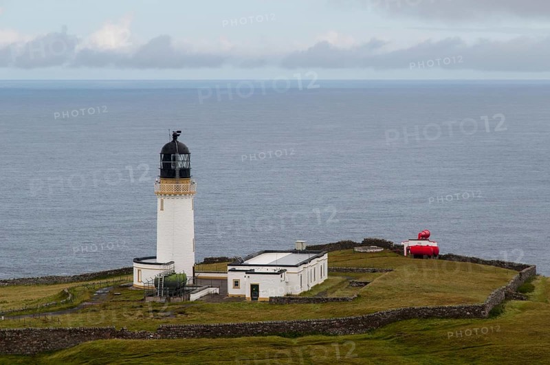 View of lighthouse and foghorn on coastal clifftop