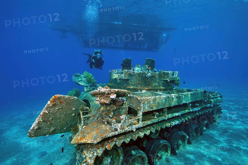 Glass bottom boat and sunken tank at Seven Sisters dive site