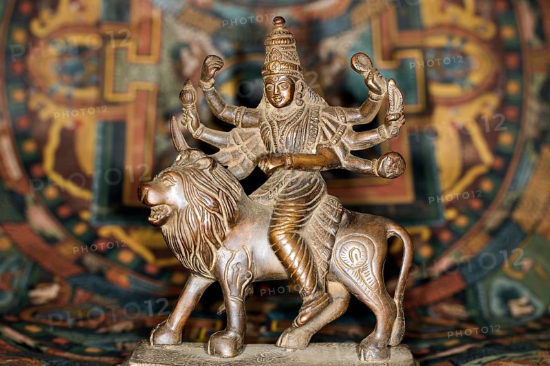 Bronze figure of the Indian goddess Durga riding on a lion figurine