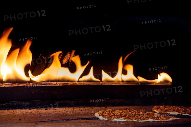 The yellow flames in a stone oven in display