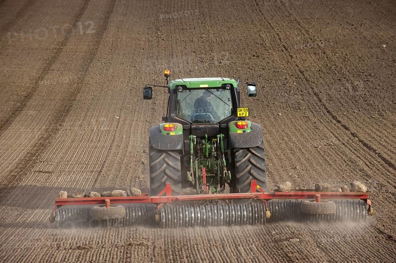 John Deere tractor pulling the soil press