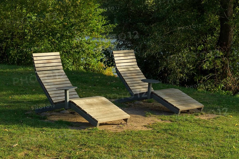 Wooden loungers on the river bank