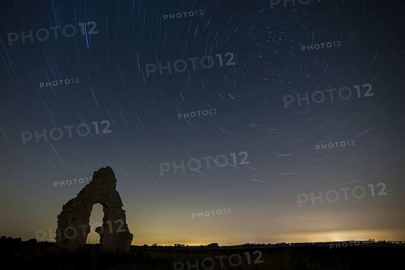Church ruins and star trails at night