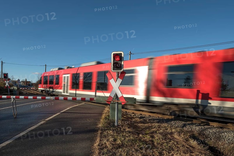 Passing train at a level crossing with barriers