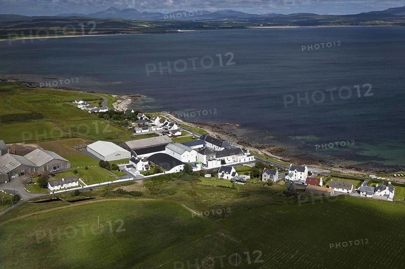 Aerial view of coastline with village and whisky distillery