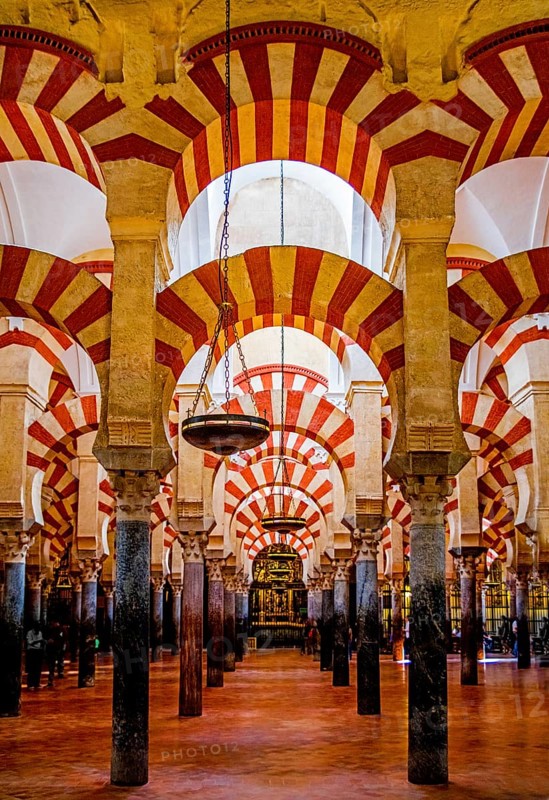 Forest of columns with alternating use of brick and stone and red and white paint