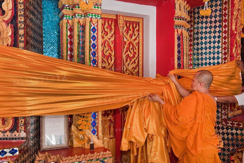 Monk attaches Songkran temple decoration
