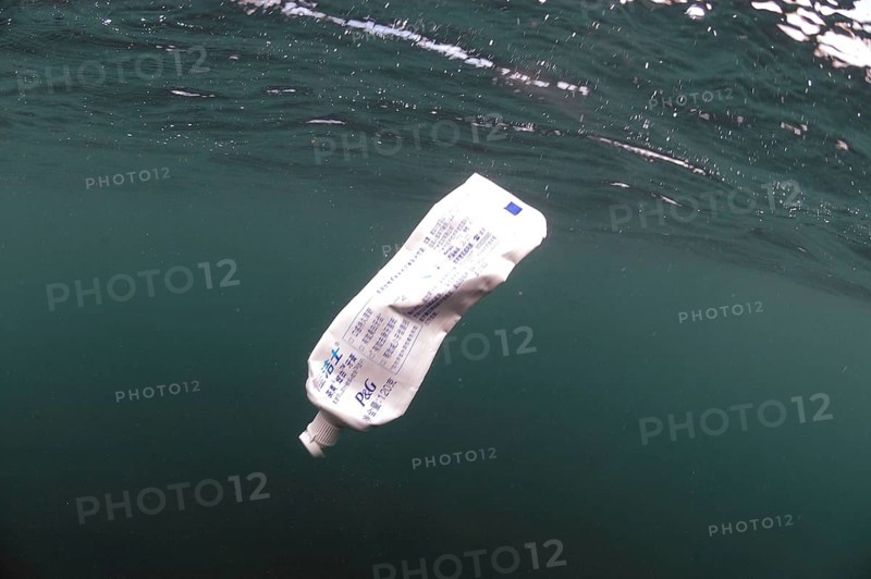 Toothpaste tube floating in sea