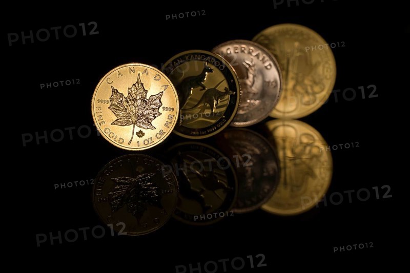 Four mirrored gold coins