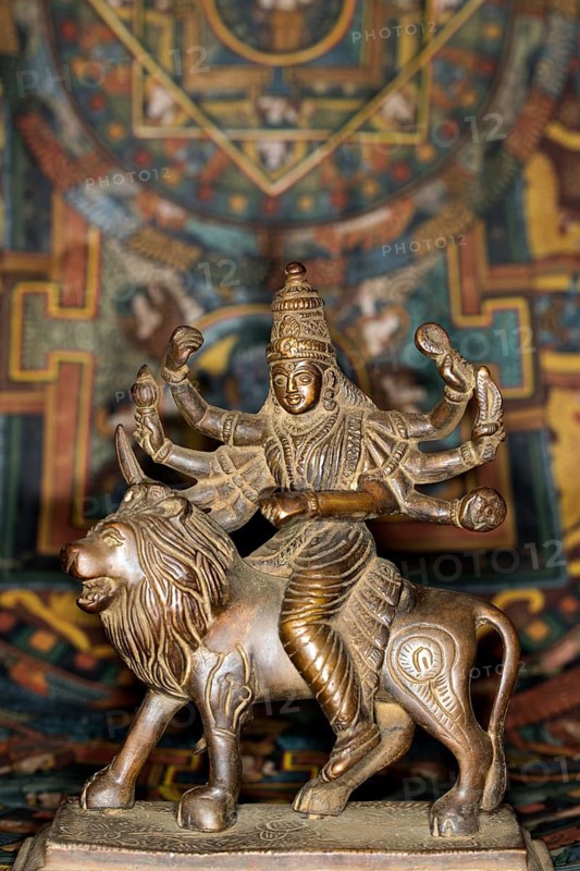 Bronze figure of the Indian goddess Durga riding on a lion figurine