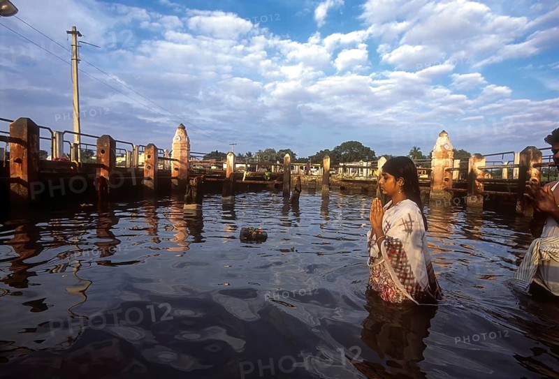 A girl worshipping Navagraha idols