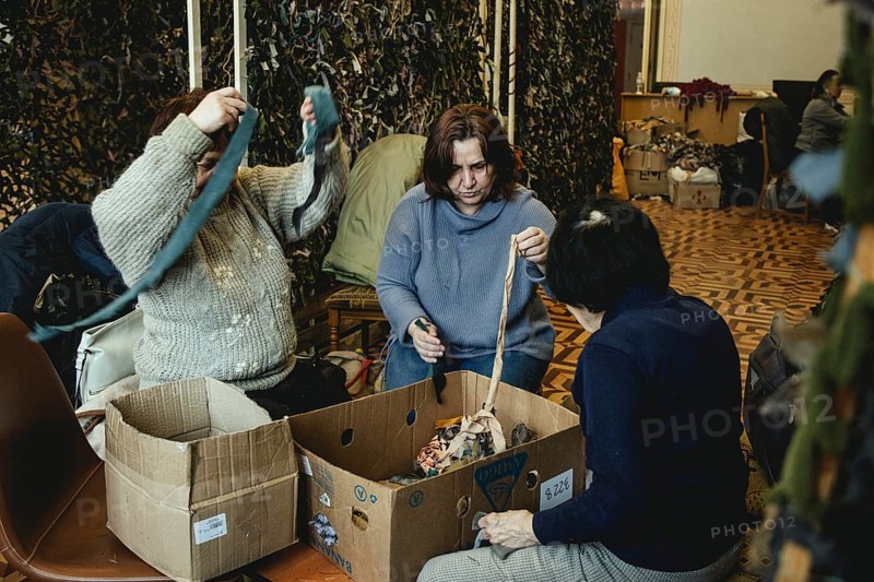 Women and young people knotting camouflage nets in the Youth and Children's Library