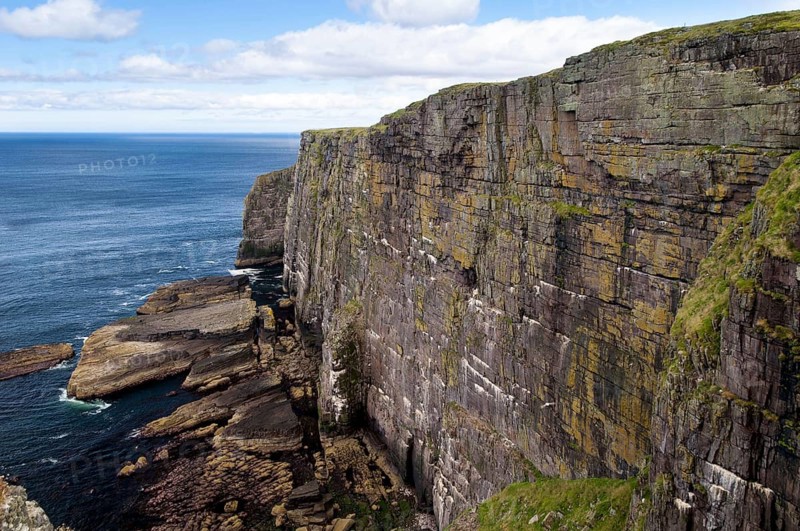 View of Torridonian red sandstone sea cliffs in northwest of island