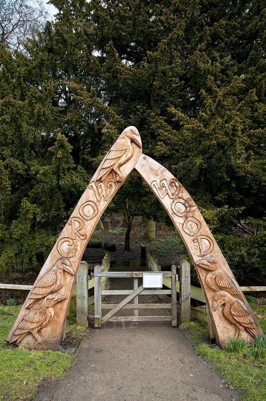Carved wooden arch at entrance to woodland