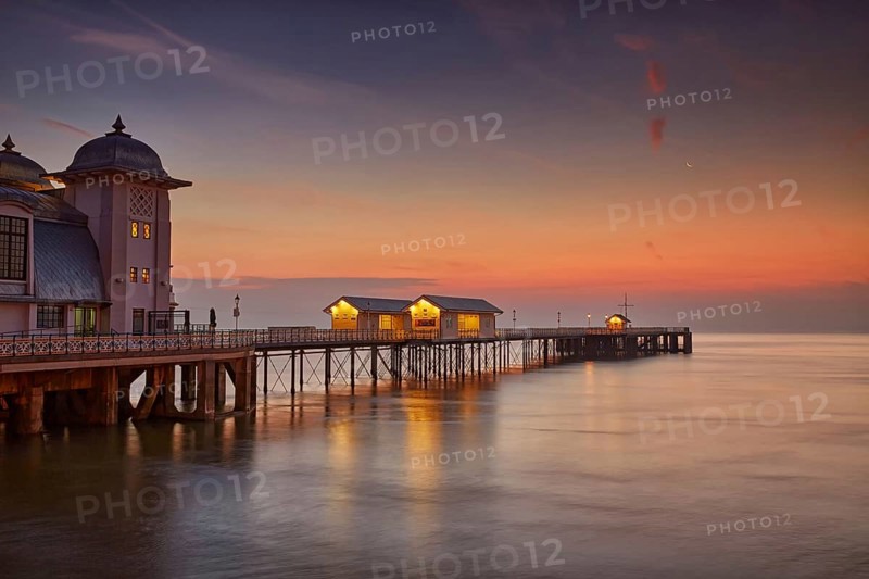 View of Victorian pier in seaside town at sunrise