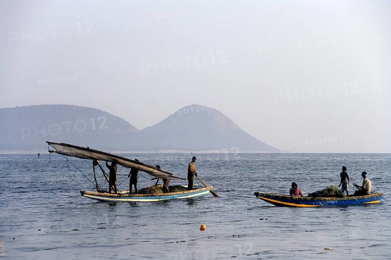 Fishermen rolling the Sailing boat cloth