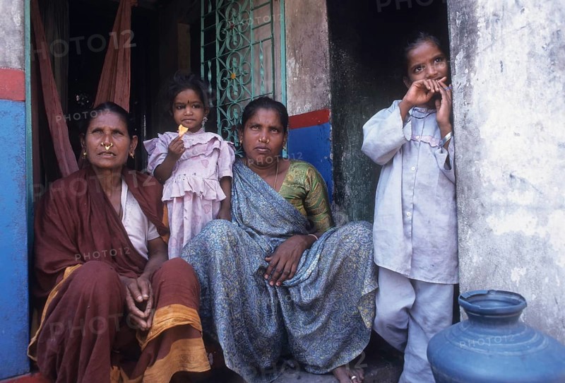 Fisher women sitting infront of the house