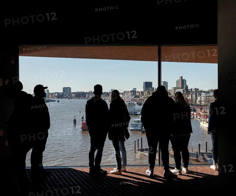 Visitors standing at the window of the public viewing platform
